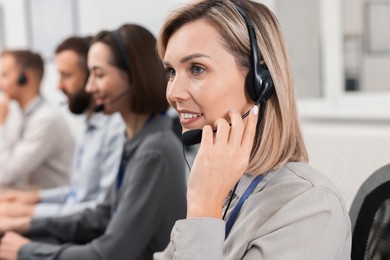 Photo of Technical support call center. Team of operators working in office