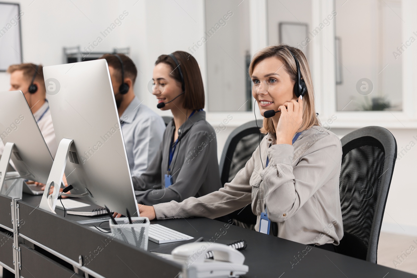 Photo of Technical support call center. Team of operators working in office