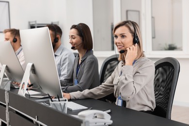 Photo of Technical support call center. Team of operators working in office