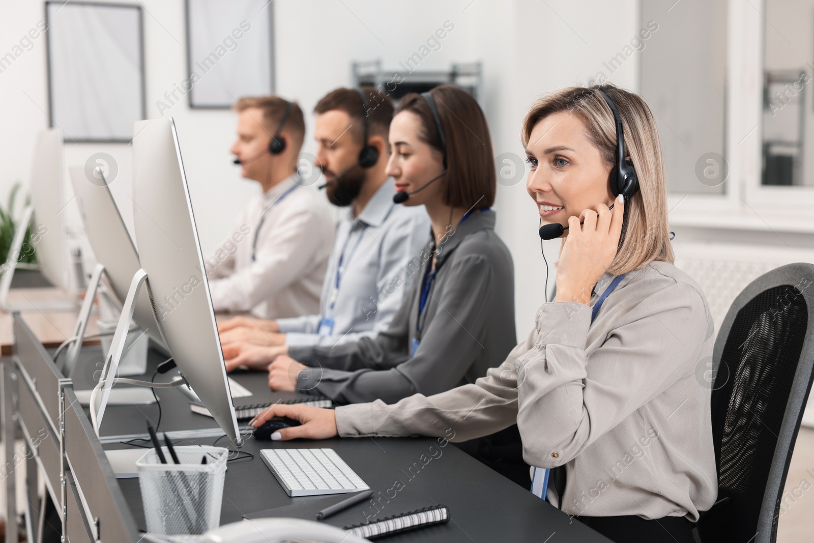 Photo of Technical support call center. Team of operators working in office