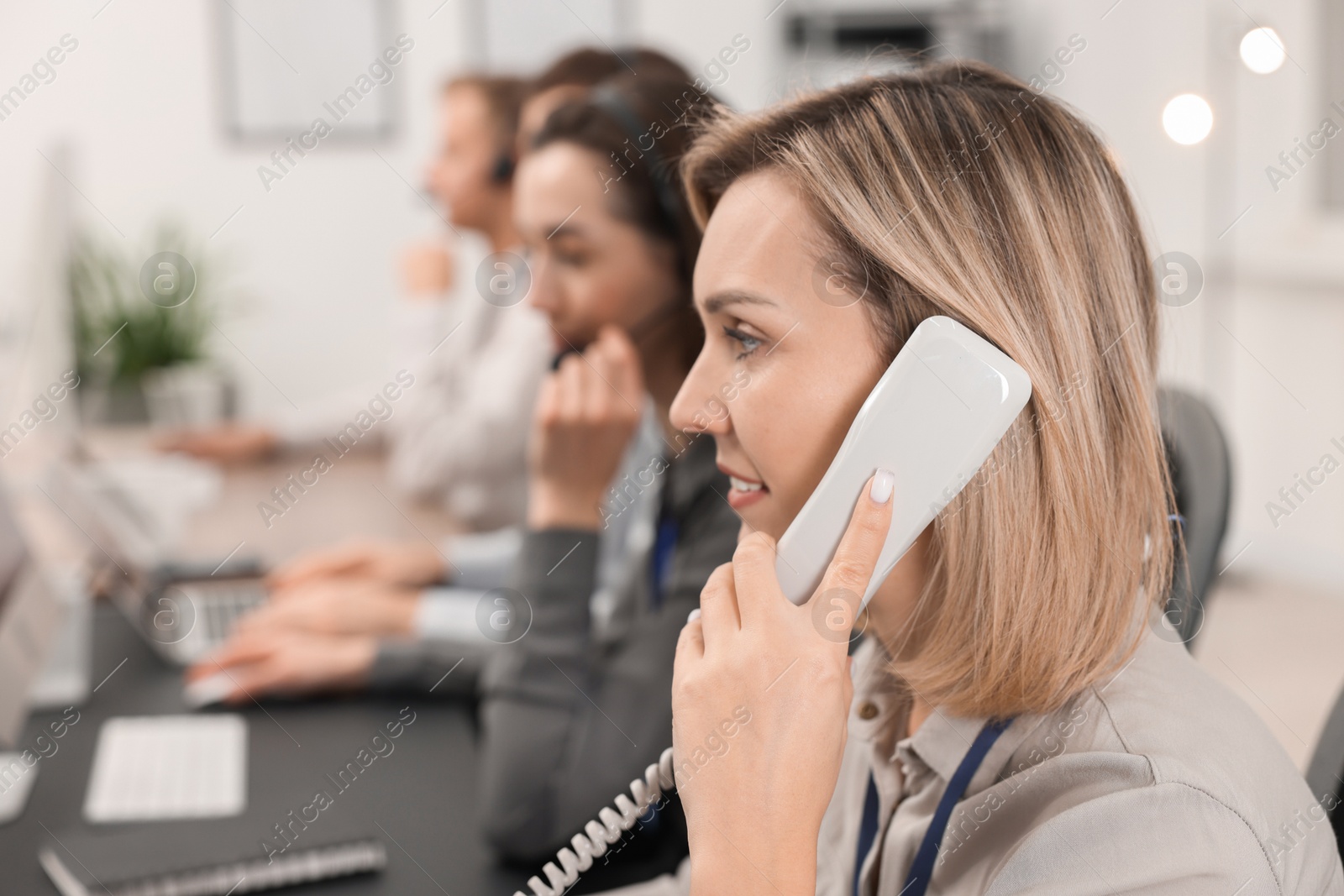 Photo of Technical support call center. Team of operators working in office