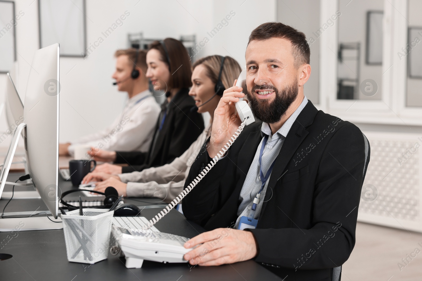 Photo of Technical support call center. Team of operators working in office