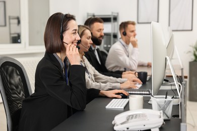 Photo of Technical support call center. Team of operators working in office