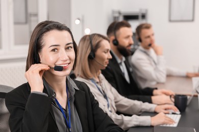 Photo of Technical support call center. Team of operators working in office