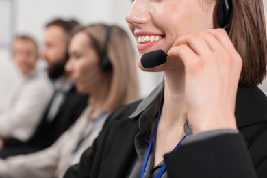 Photo of Technical support call center. Team of operators working in office, selective focus