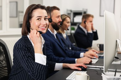 Photo of Technical support call center. Team of operators working in office