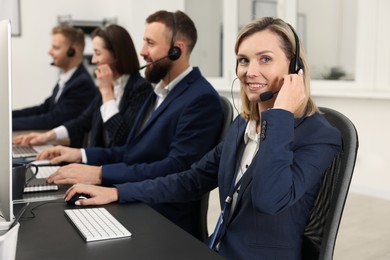 Photo of Technical support call center. Team of operators working in office