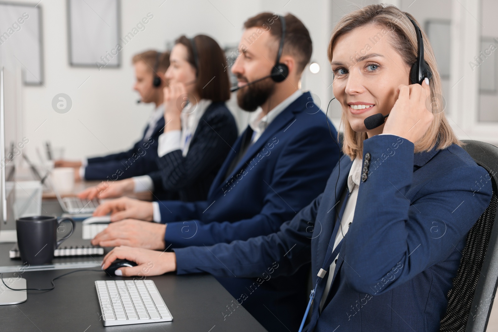 Photo of Technical support call center. Team of operators working in office