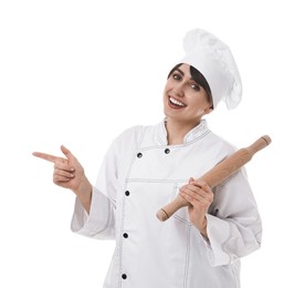 Photo of Professional chef with rolling pin pointing at something on white background