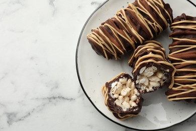 Photo of Delicious chocolate puffed rice bars on white marble table, top view. Space for text