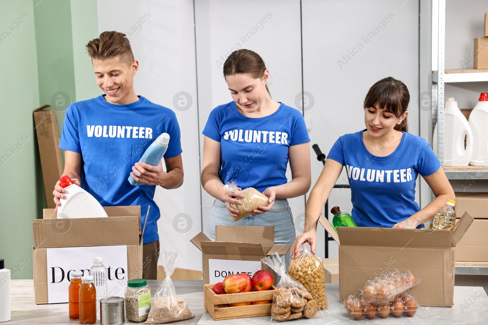 Photo of Volunteers packing food donations at tables indoors