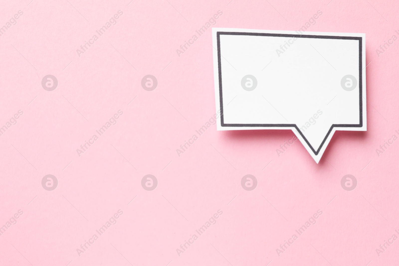 Photo of Blank speech bubble on light pink background, top view. Space for text