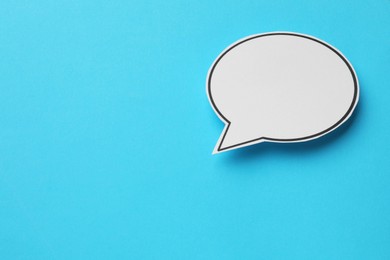 Photo of Blank speech bubble on light blue background, top view. Space for text