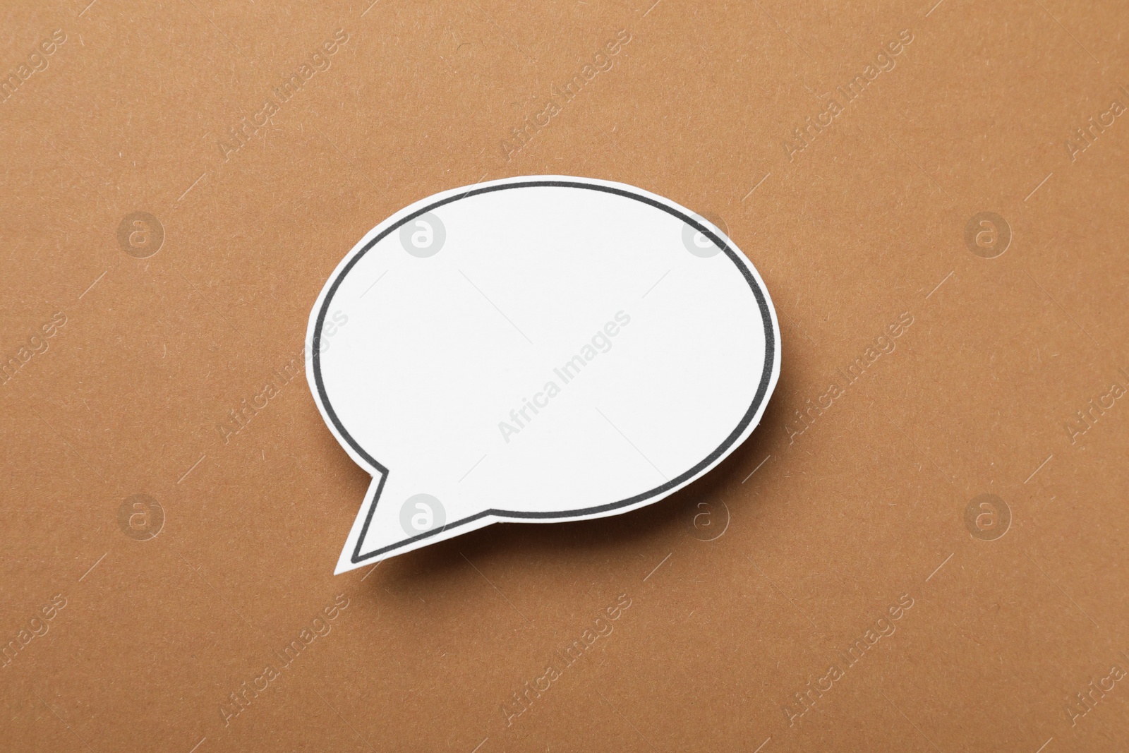 Photo of Blank speech bubble on brown background. Space for text