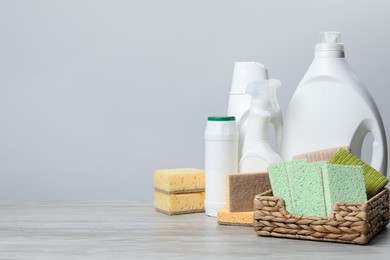 Photo of Eco-friendly cleaning products and supplies on wooden table, space for text