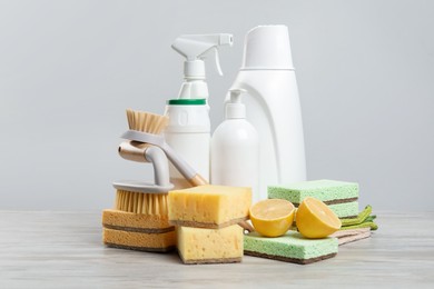 Photo of Eco-friendly cleaning products and supplies on wooden table