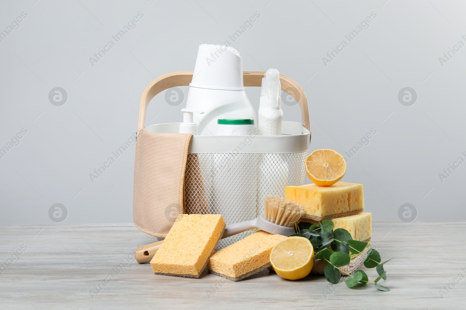 Photo of Eco-friendly cleaning products, supplies and eucalyptus branches on wooden table