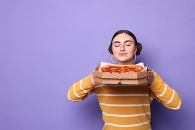 Beautiful woman with delicious pizza on violet background, space for text