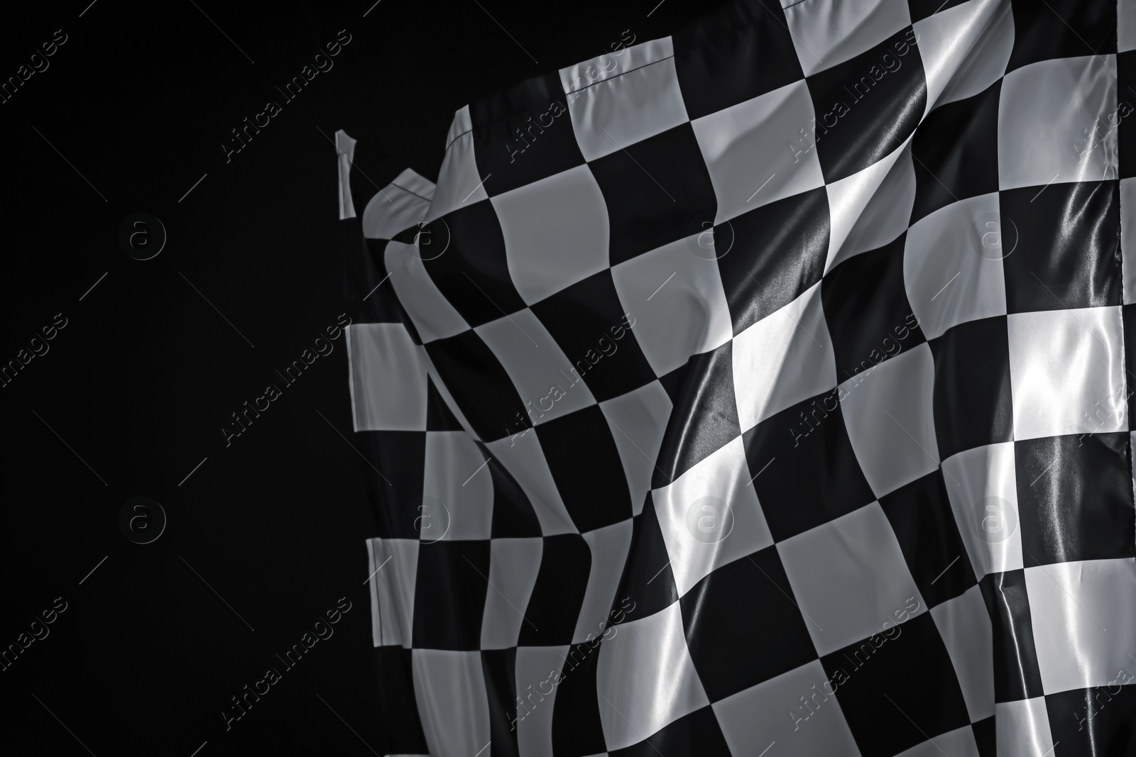 Photo of One racing checkered flag on black background, space for text