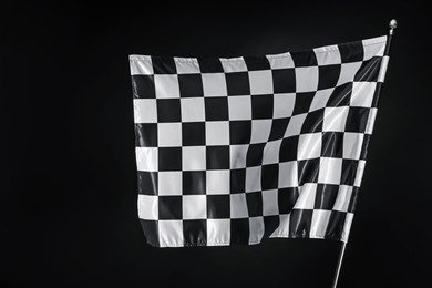 Photo of One racing checkered flag on black background