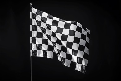 Photo of One racing checkered flag on black background