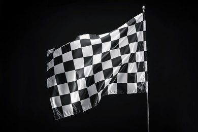 Photo of One racing checkered flag on black background