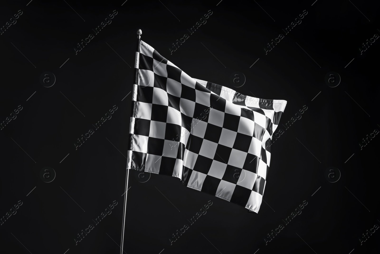 Photo of One racing checkered flag on black background