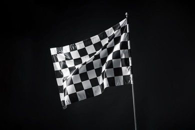 Photo of One racing checkered flag on black background