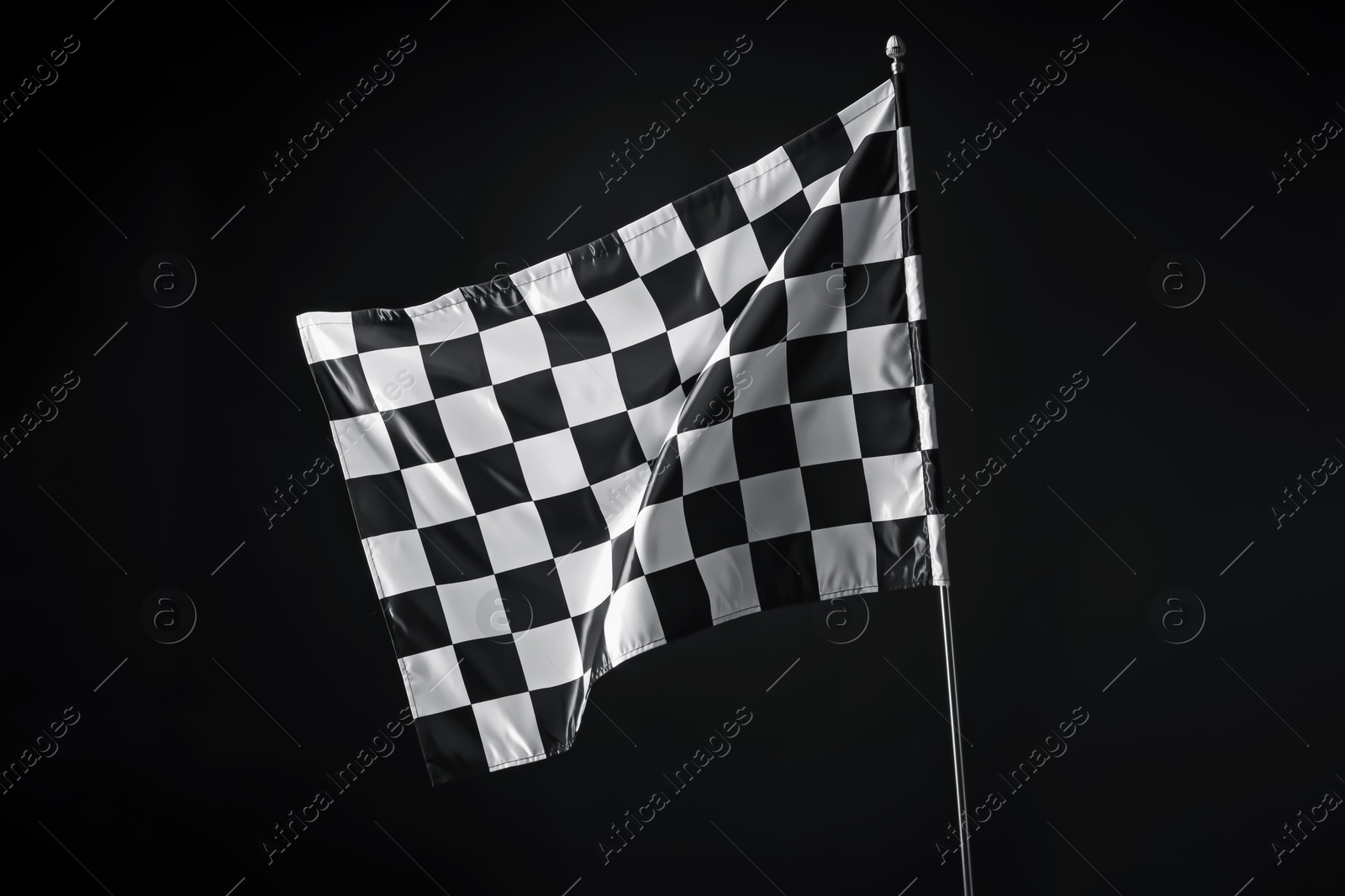 Photo of One racing checkered flag on black background