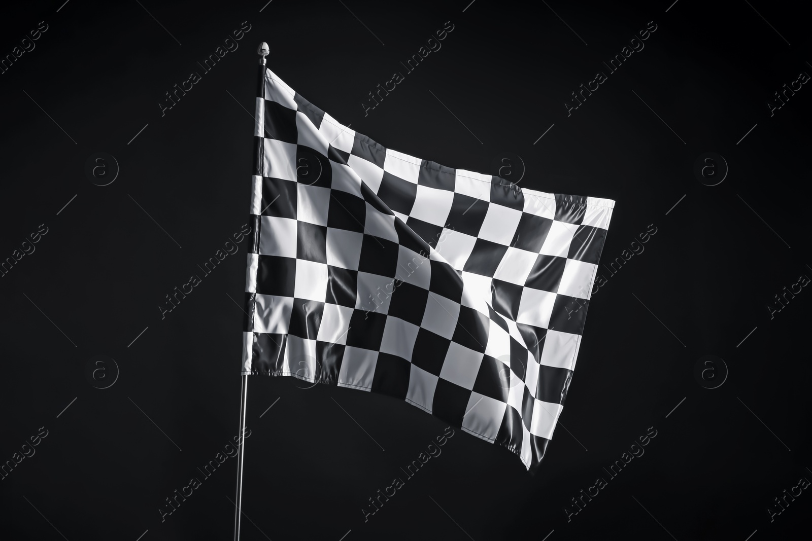 Photo of One racing checkered flag on black background