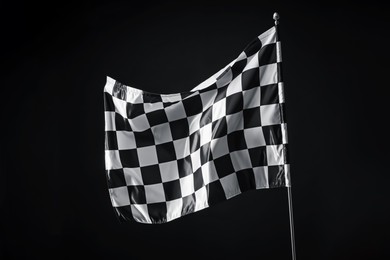 Photo of One racing checkered flag on black background