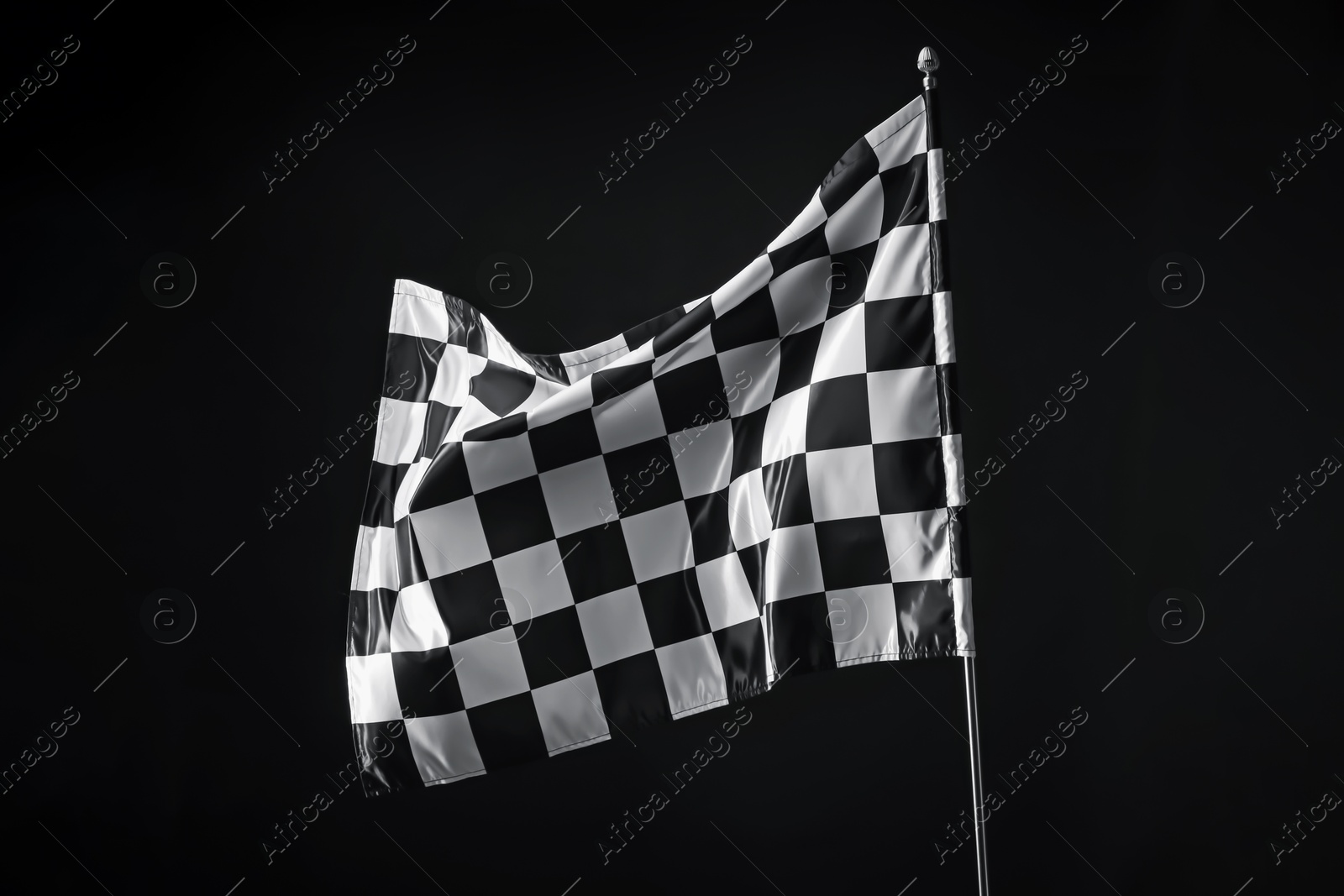 Photo of One racing checkered flag on black background