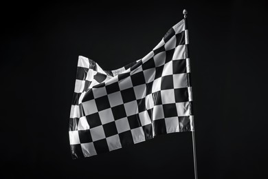 Photo of One racing checkered flag on black background