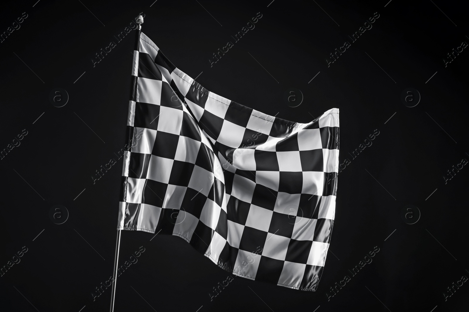 Photo of One racing checkered flag on black background