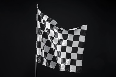 Photo of One racing checkered flag on black background