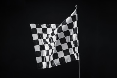 Photo of One racing checkered flag on black background