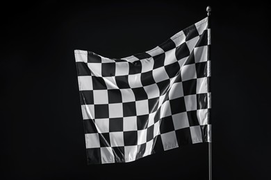 Photo of One racing checkered flag on black background