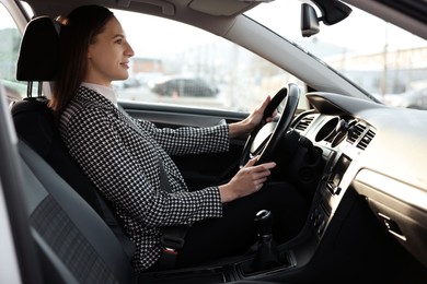 Photo of Driver behind steering wheel of modern car