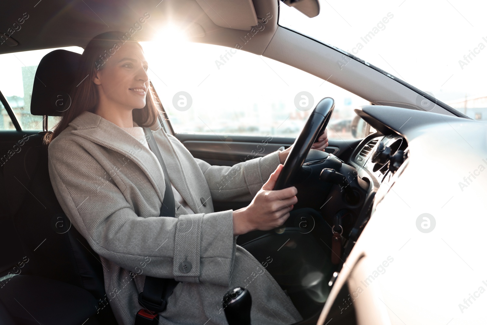 Photo of Driver behind steering wheel of modern car