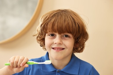 Cute boy with toothbrush at home. Personal hygiene