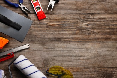 Photo of Different construction materials and tools on wooden table, flat lay. Space for text