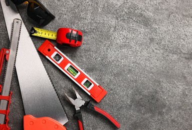 Photo of Different construction materials and tools on grey table, flat lay. Space for text