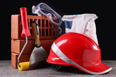 Photo of Different construction material and tools on grey table