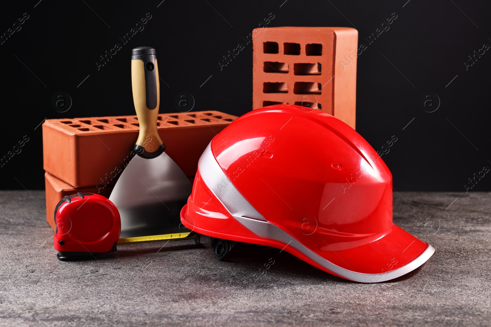 Photo of Different construction material and tools on grey table