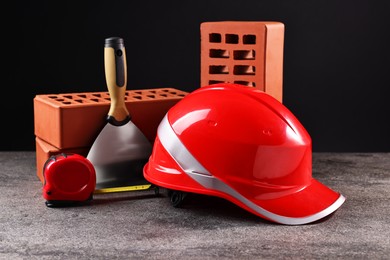 Photo of Different construction material and tools on grey table