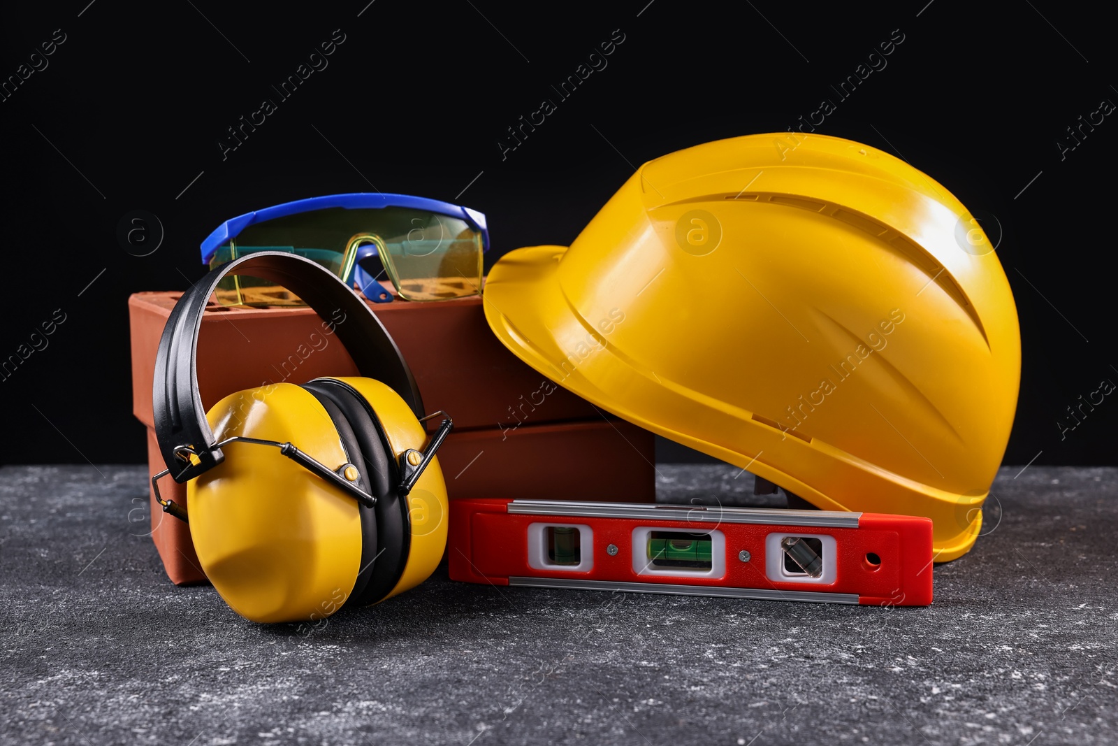 Photo of Different construction material and tools on grey table