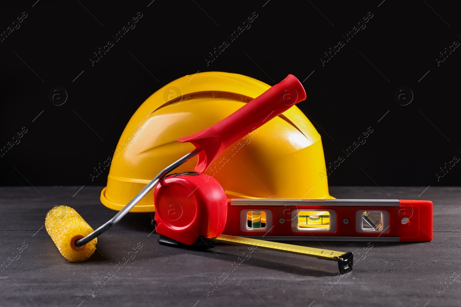 Photo of Different construction material and tools on black table