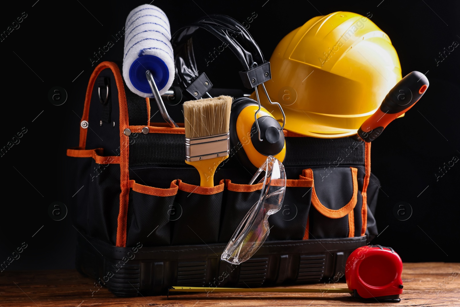 Photo of Different construction material and tools on wooden table