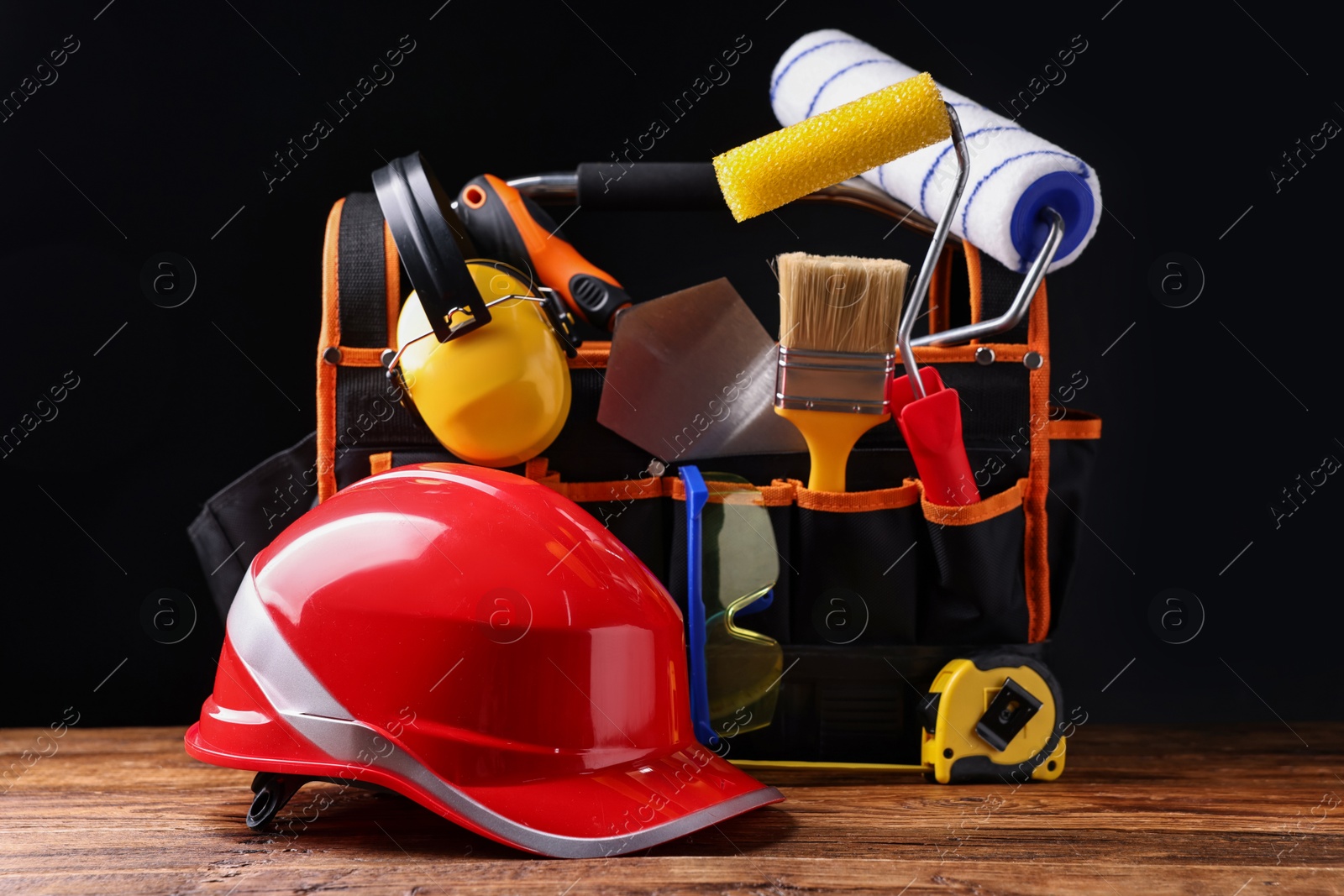 Photo of Different construction material and tools on wooden table