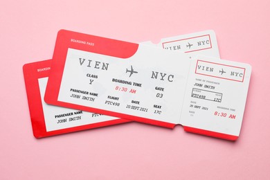 Photo of Travel agency. Flight tickets on pink background, top view